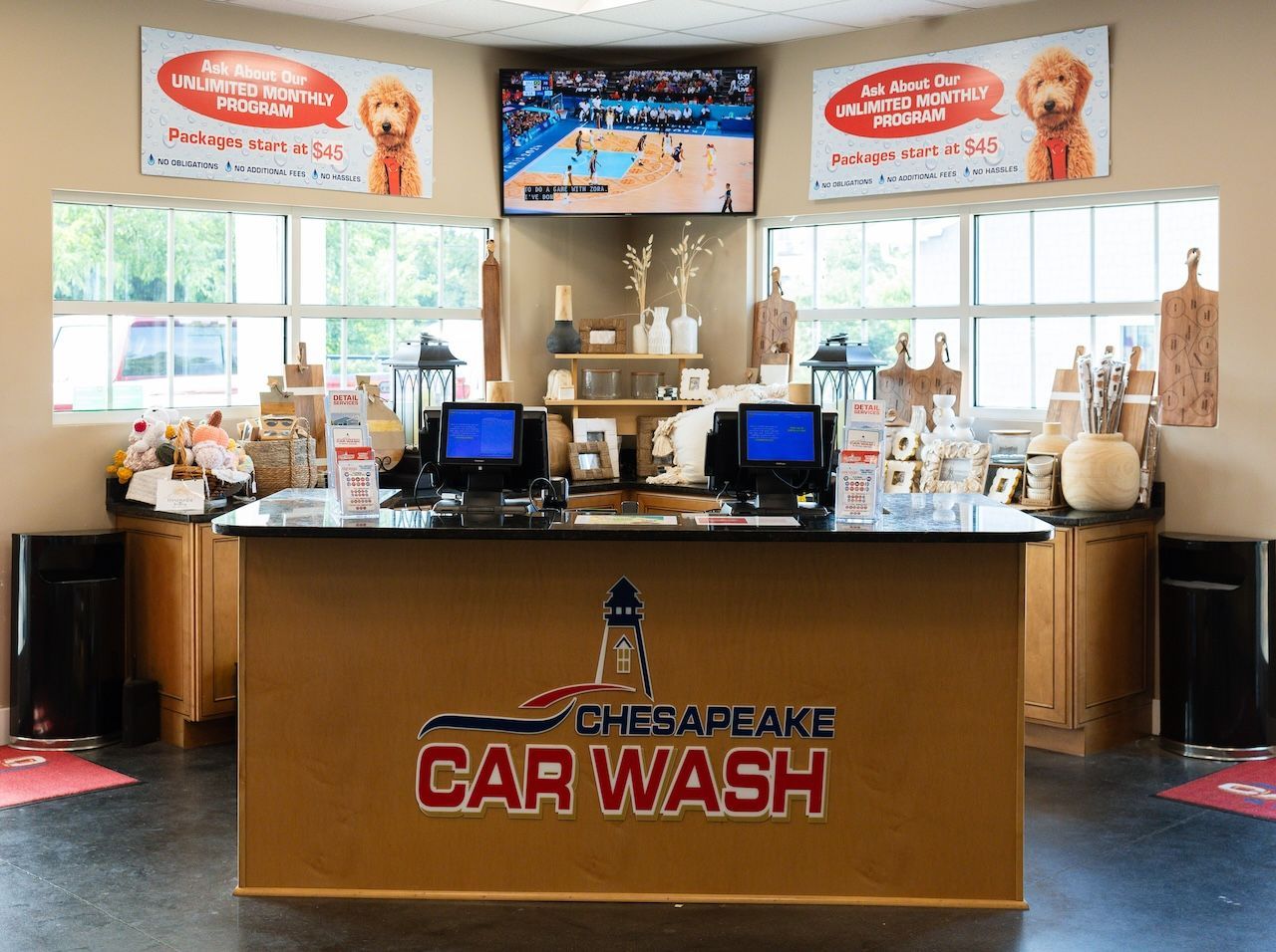 Chesapeake Car Wash counter with registers, supplies, and menu signs in a bright lobby