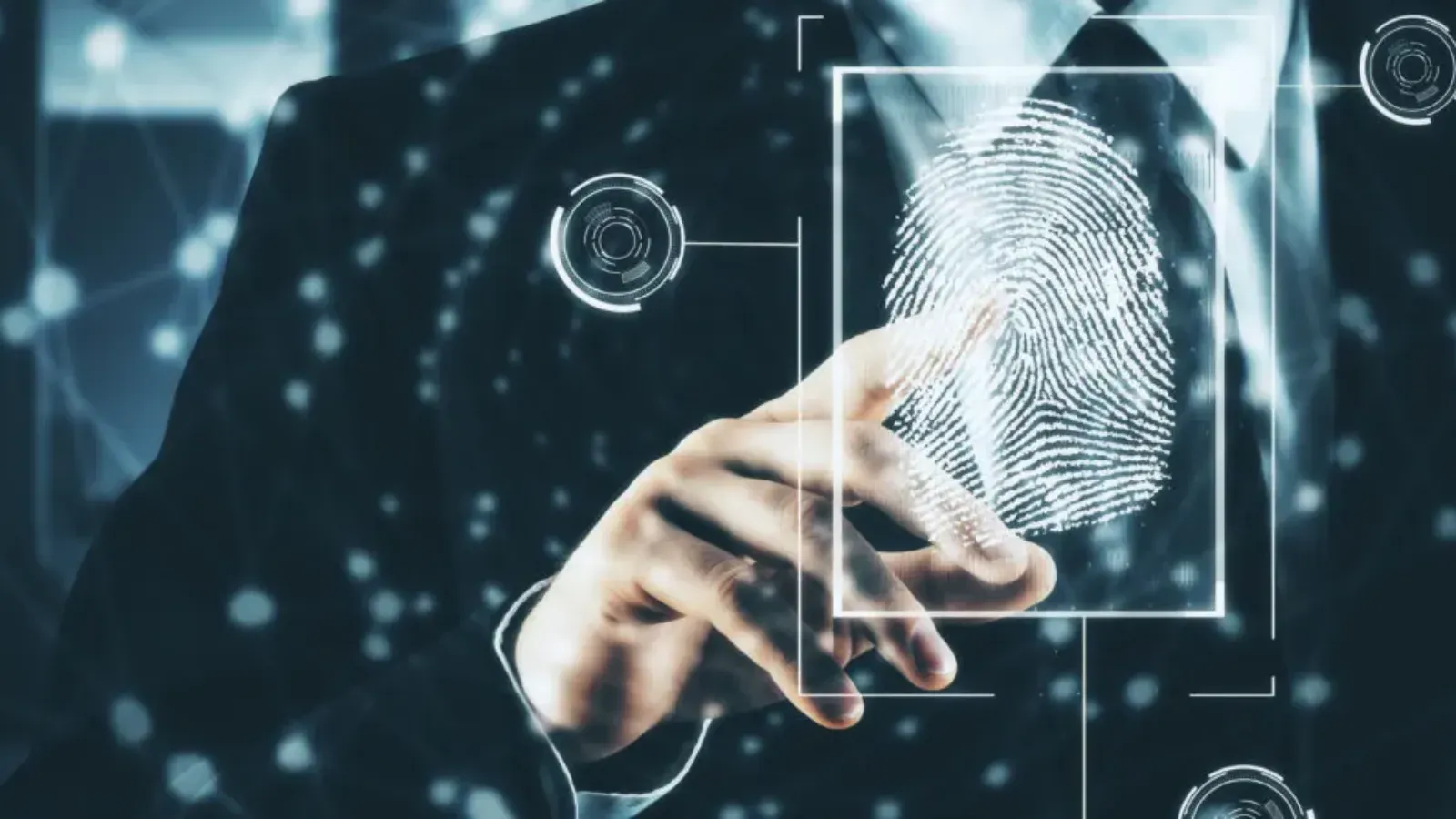 Person in suit scanning fingerprint on a glowing digital interface, futuristic tech background.