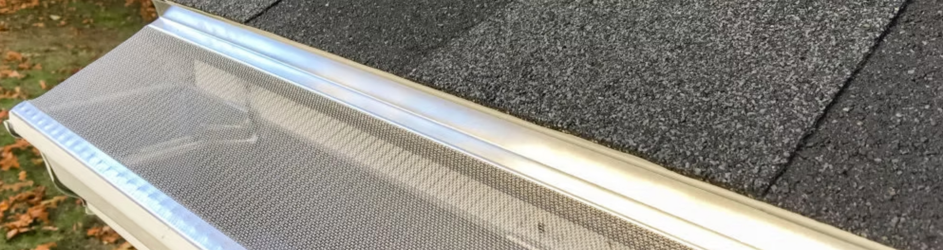 A close up of a gutter on top of a roof.