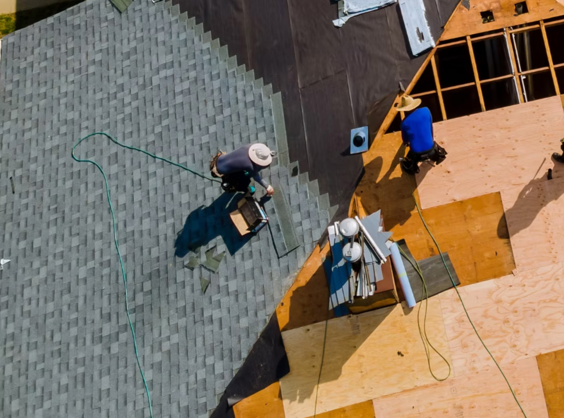 An aerial view of a roof being installed on a house