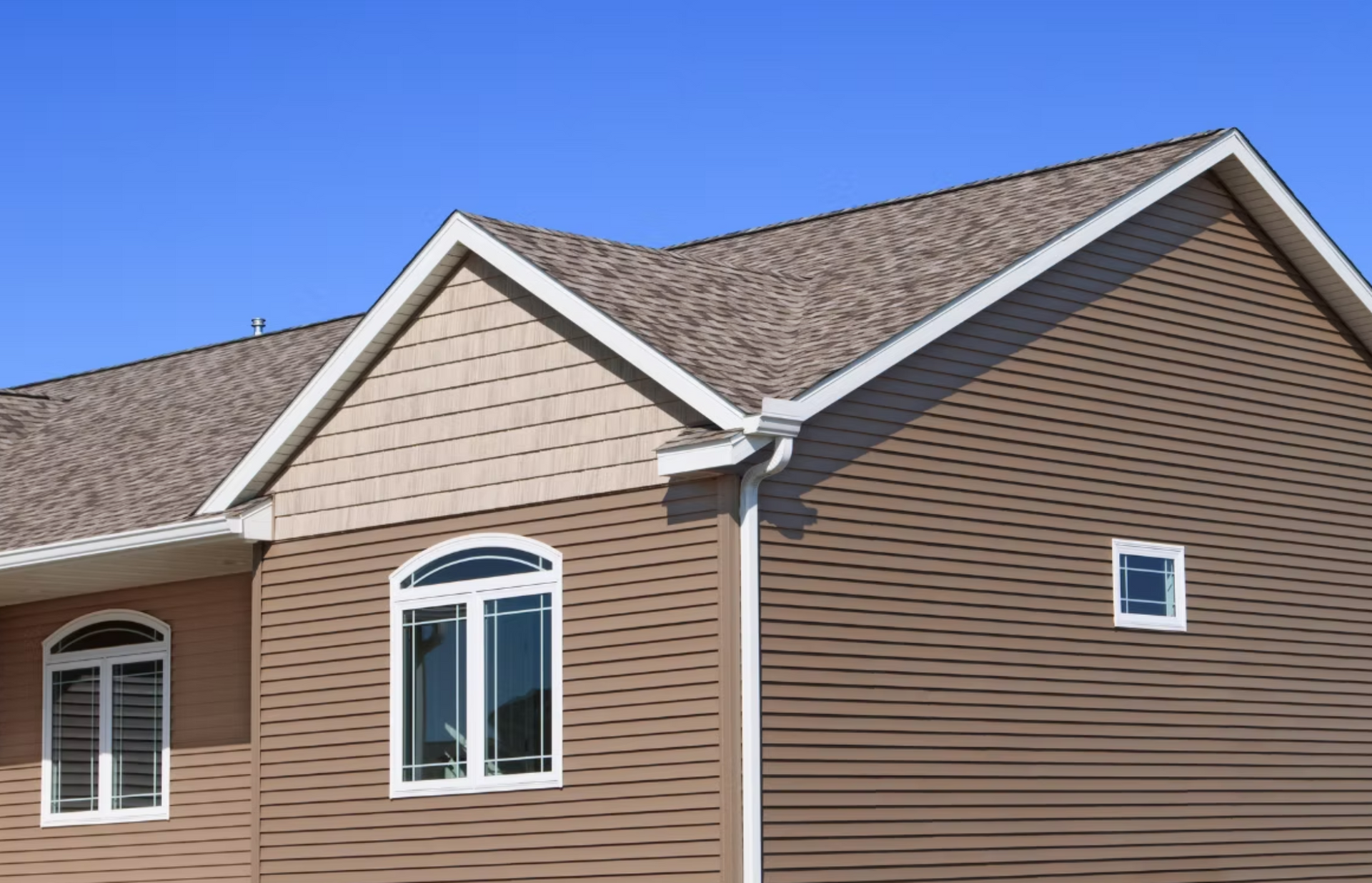 A house with a brown siding and a brown roof.
