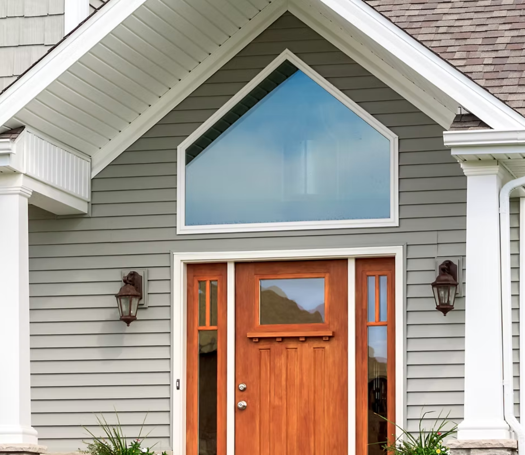 A house with a wooden door and a large window
