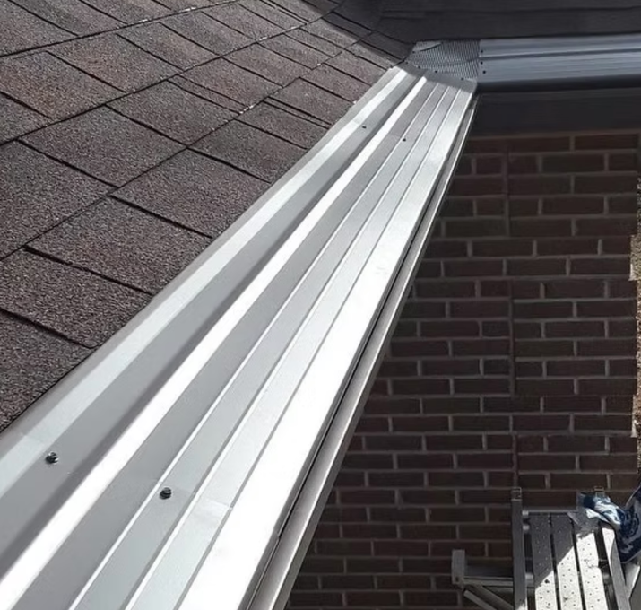 A gutter on the side of a brick building