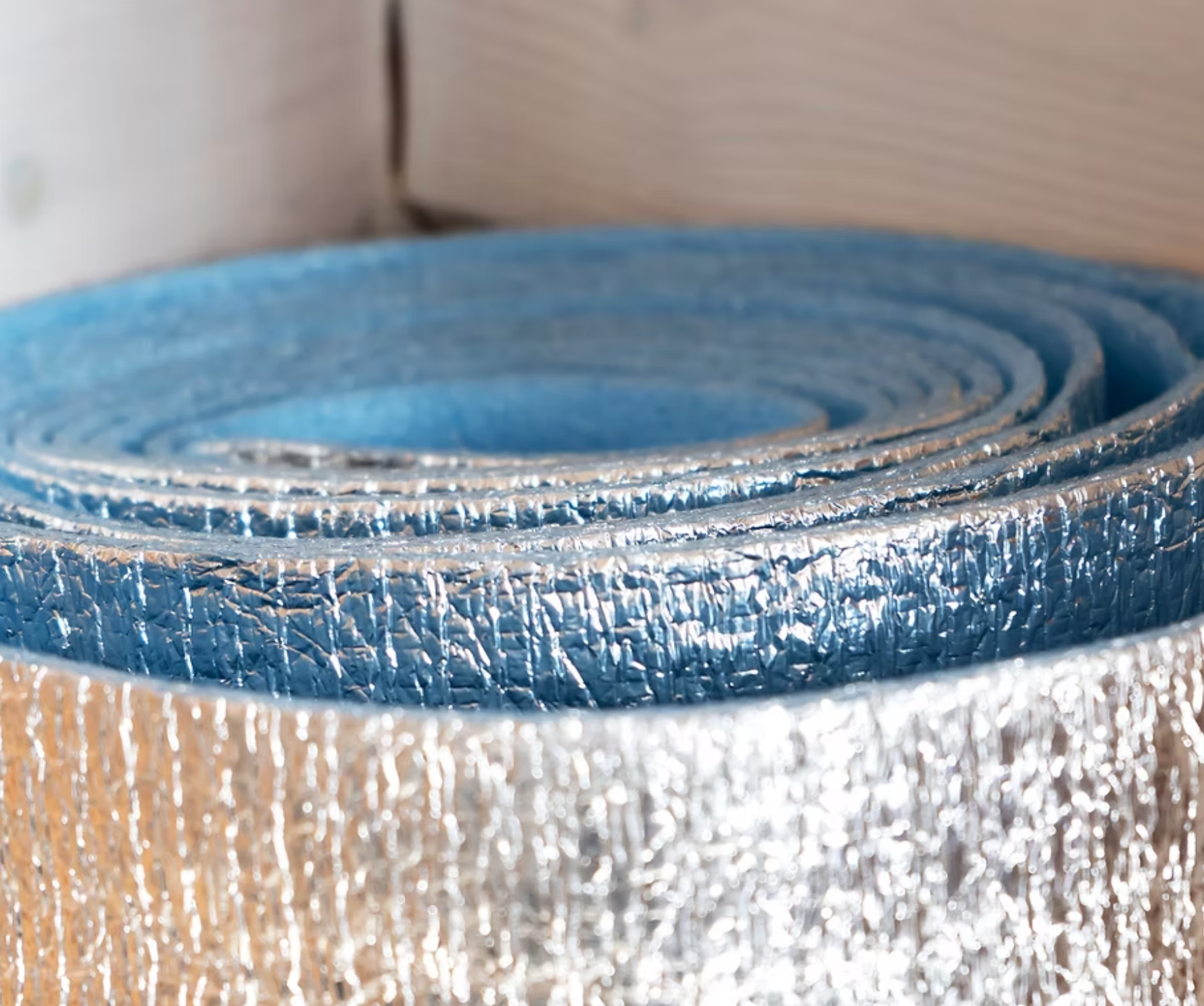 A close up of a roll of aluminum foil on a table.