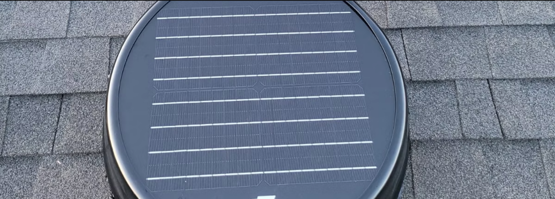 A solar panel is sitting on top of a roof.