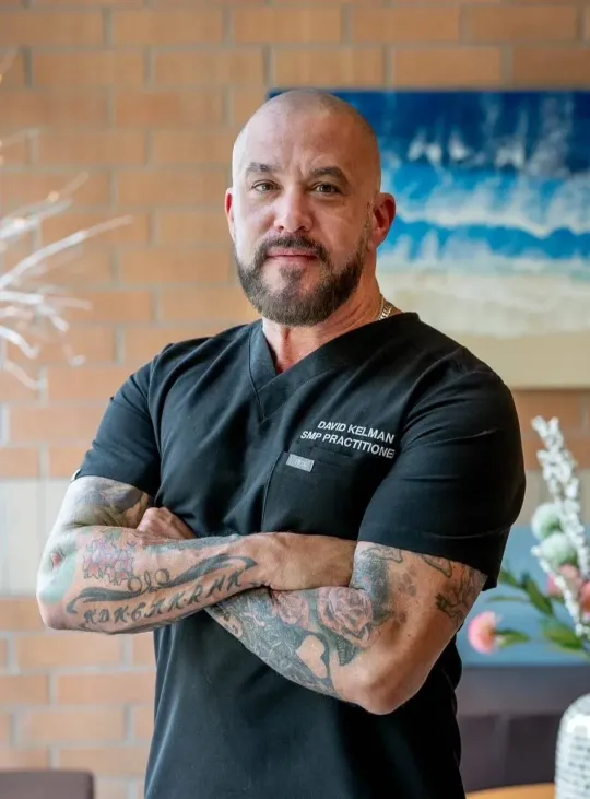 headshot of David Kelman a barber and owner of Deluxe Barbershop