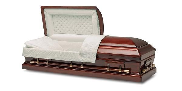An open, wooden coffin with white interior, ready for a burial.
