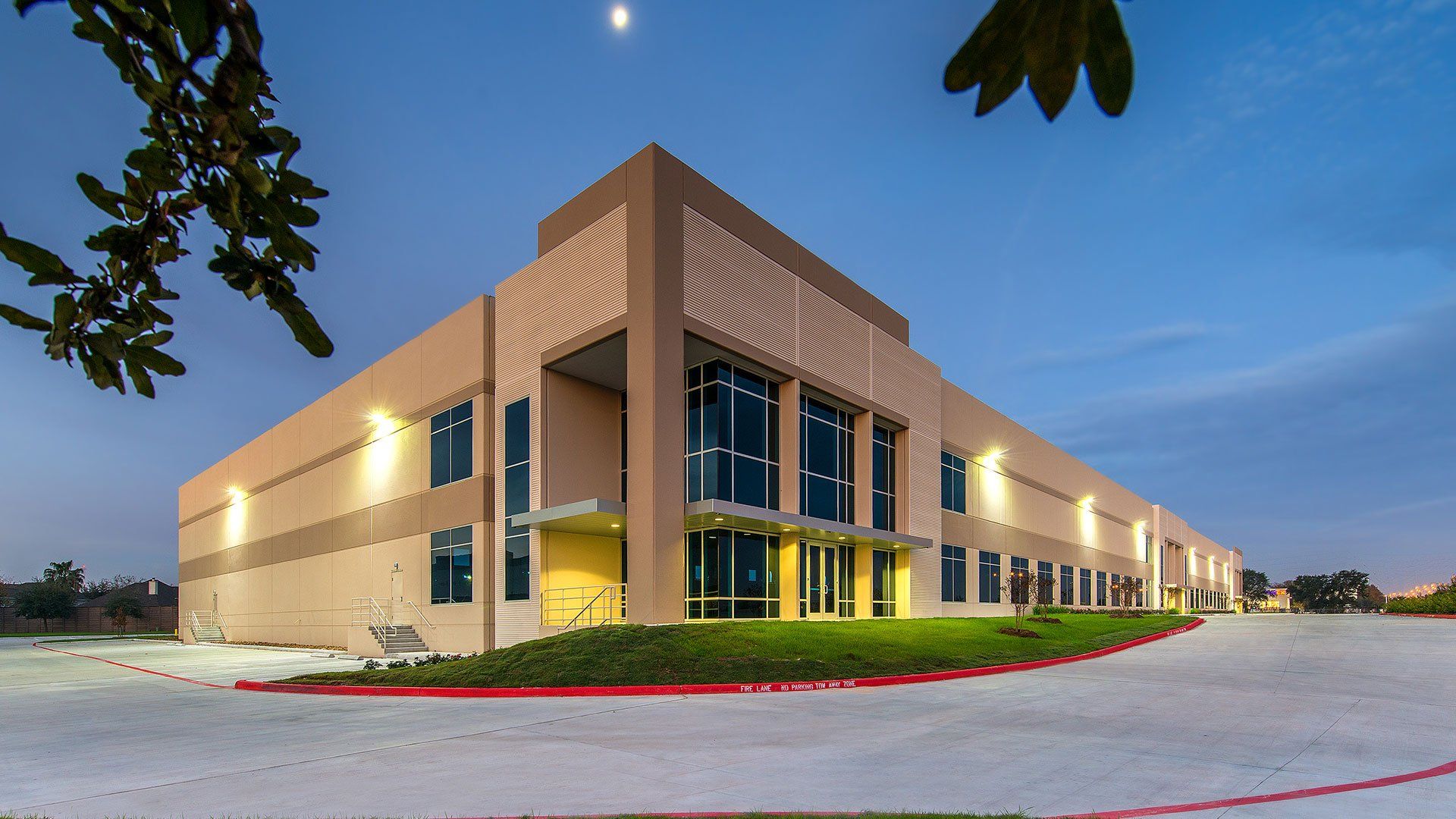 A large building with a lot of windows is lit up at night