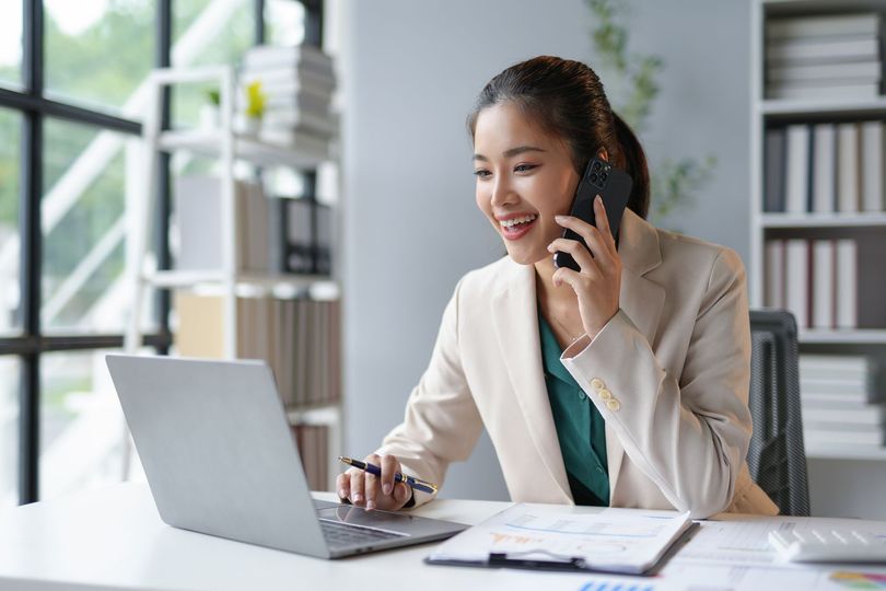 Tax consultant assisting a client over the phone — Ovation Tax Group