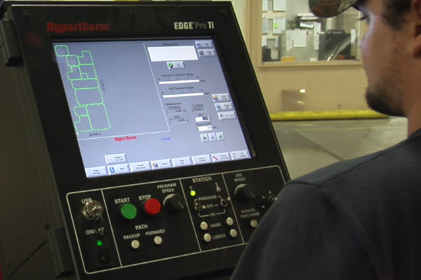 A man is working on a machine with a screen that says ' ebc pro 11 ' on it