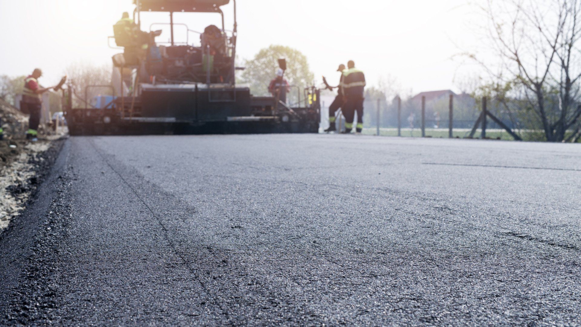 Workers placing new coating of asphalt - Wendell, NC l Champ's Paving & Seal Coating INC