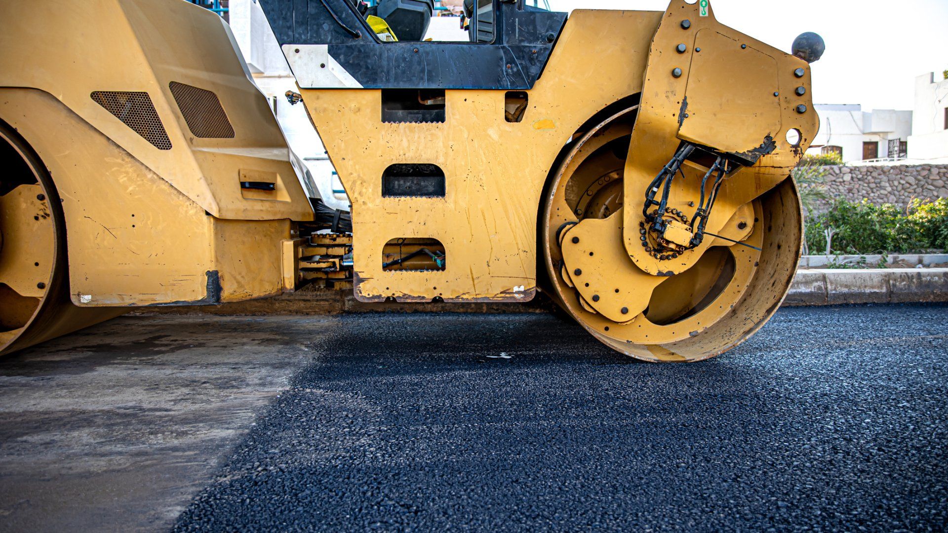 Road roller compacting asphalt - Wendell, NC l Champ's Paving & Seal Coating INC