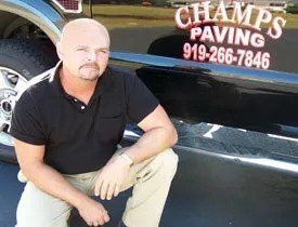 Residential paving - Man crouching near black van in Wendell, NC