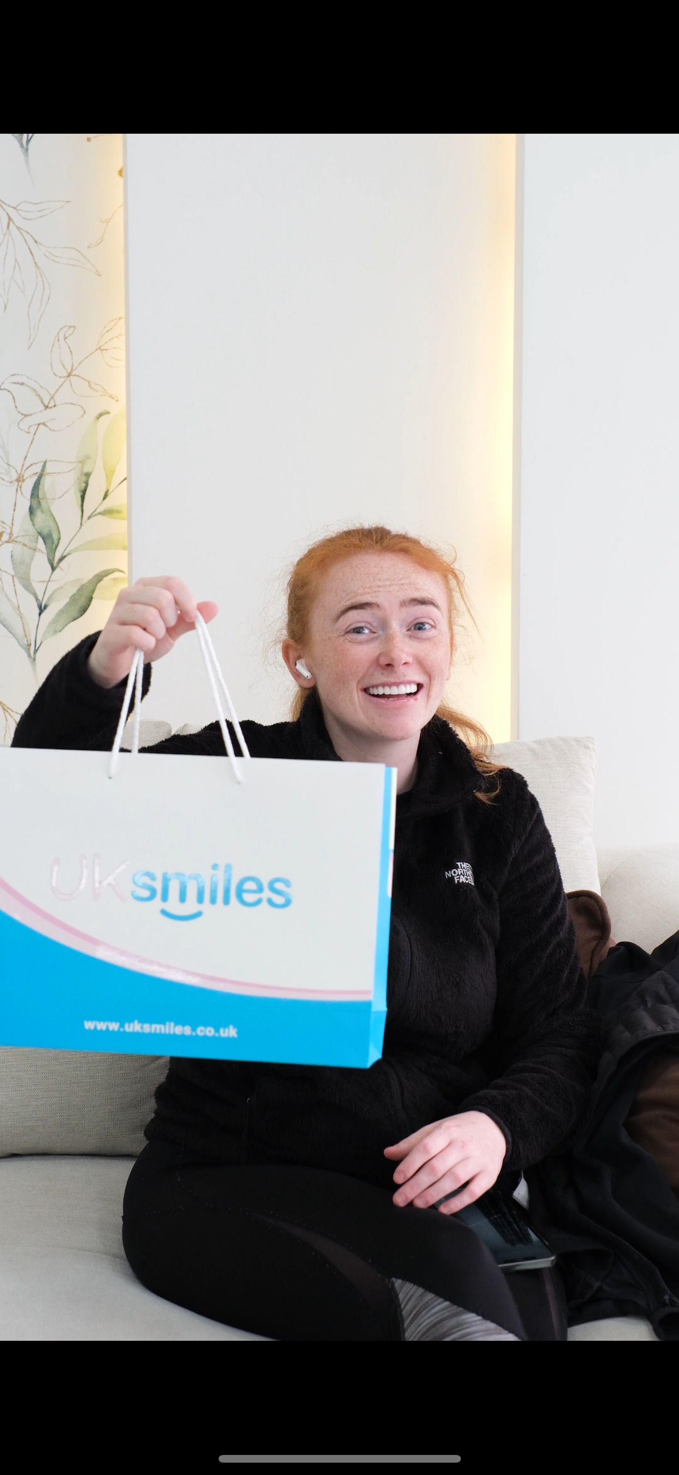 Woman with red hair holding a bag from