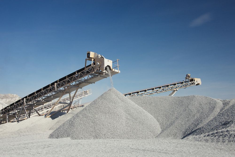 Two Conveyor Belts Are Stacked On Top Of A Pile Of Gravel — Macquarie Valley Rock & Sand In Trangie, NSW