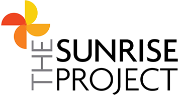 Logo for The Sunrise Project: a flower-like design in shades of orange and yellow, with the text 