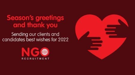 Red holiday graphic with heart, hands, and text: 