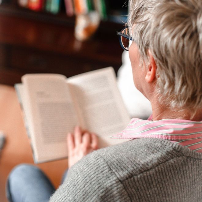 Eine Frau mit Brille liest ein Buch