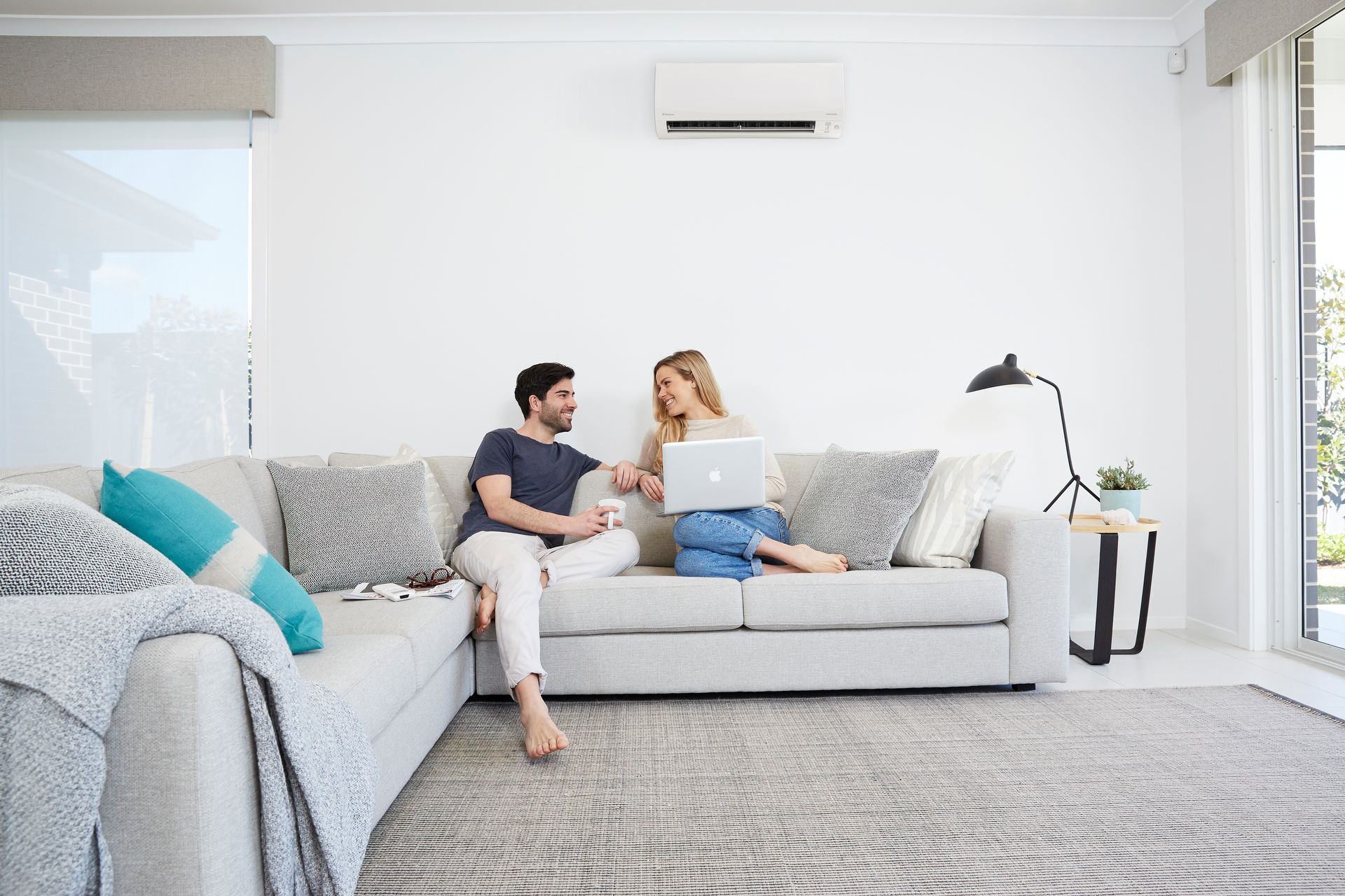 A Couple Smiling Each Other with Aircon on the Top of It | Batemans Bay, NSW