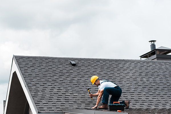 Man Repairing Roof — Pittsfield, MA — R & T Roofing