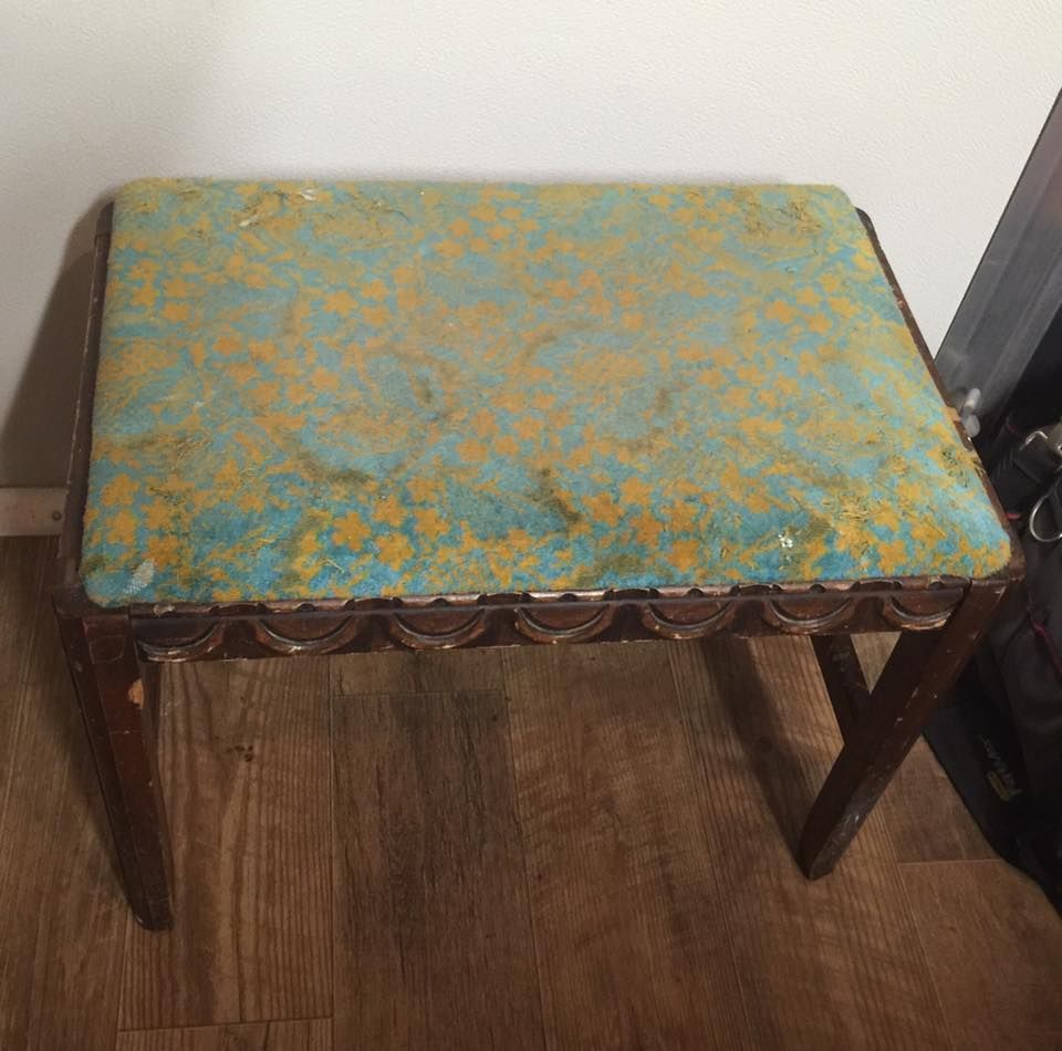Wooden vanity stool with teal and gold patterned cushion.