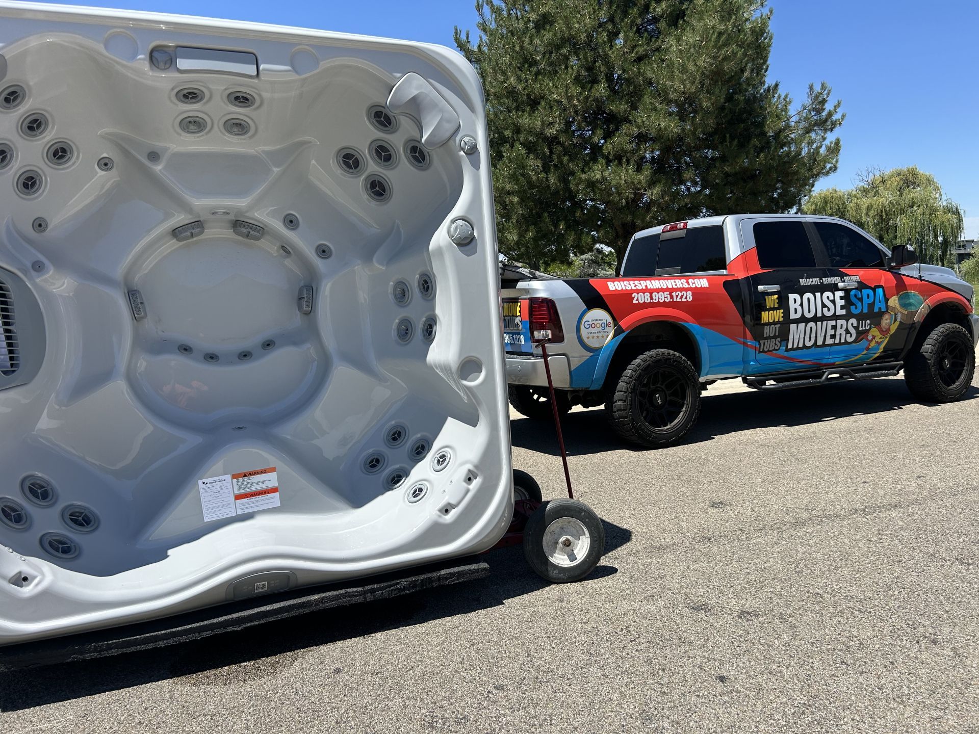 Hot tub on a dolly being towed by a truck with 