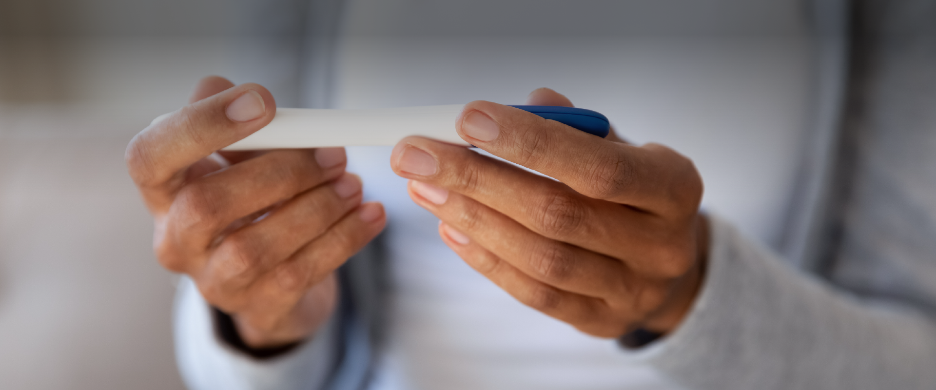 woman looking at a pregnancy test