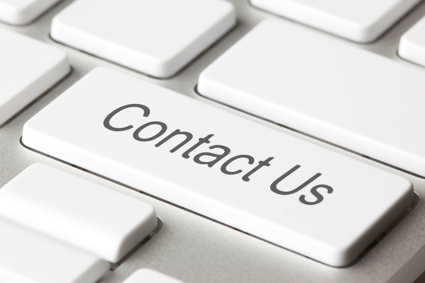 A close up of a keyboard with a contact us button