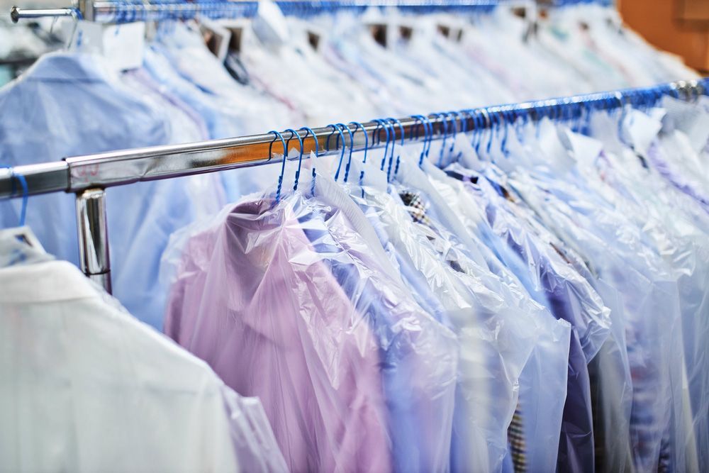 A Row Of Shirts Hanging On A Rack In A Dry Cleaner — Buderim Laundrette In Buderim, QLD