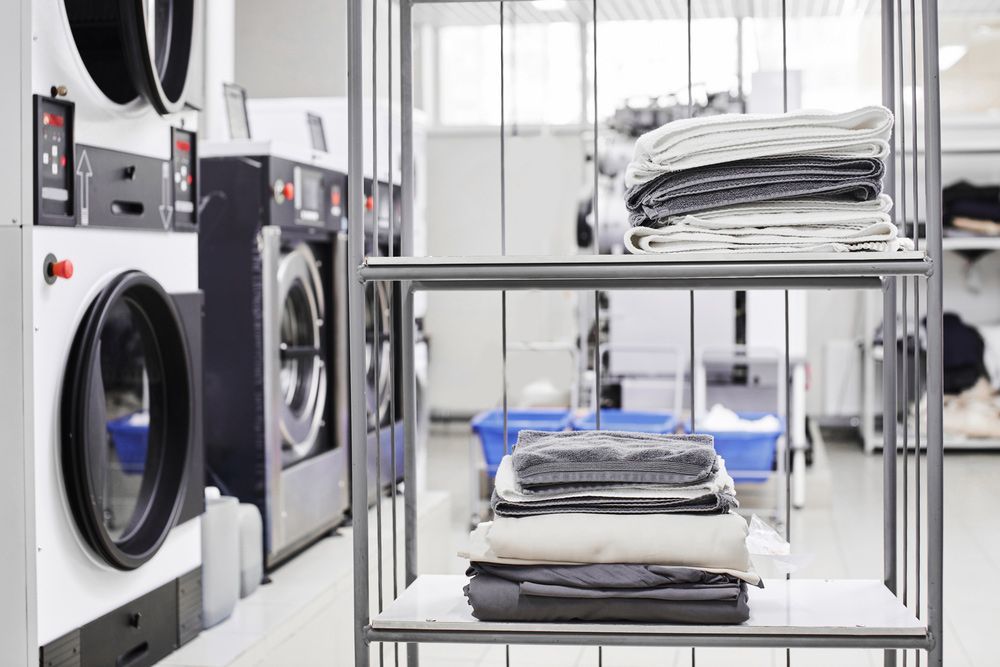 A Laundromat With A Stack Of Clothes On A Shelf — Buderim Laundrette In Buderim, QLD