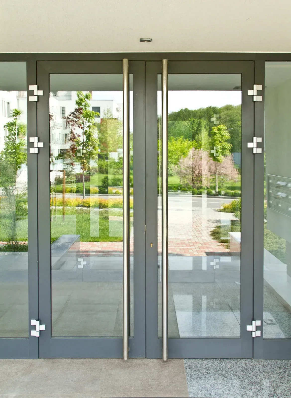 A pair of glass doors with a stainless steel handle