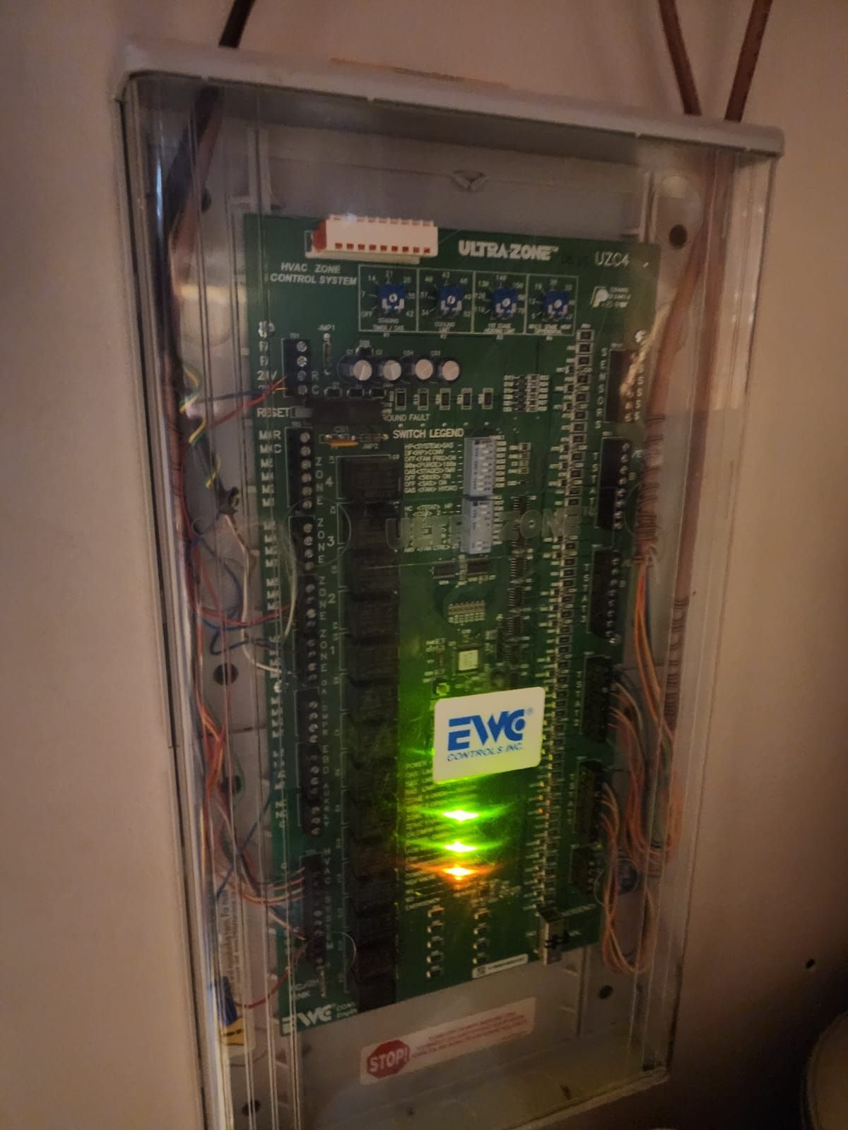 A close up of a circuit board with a green light on it.