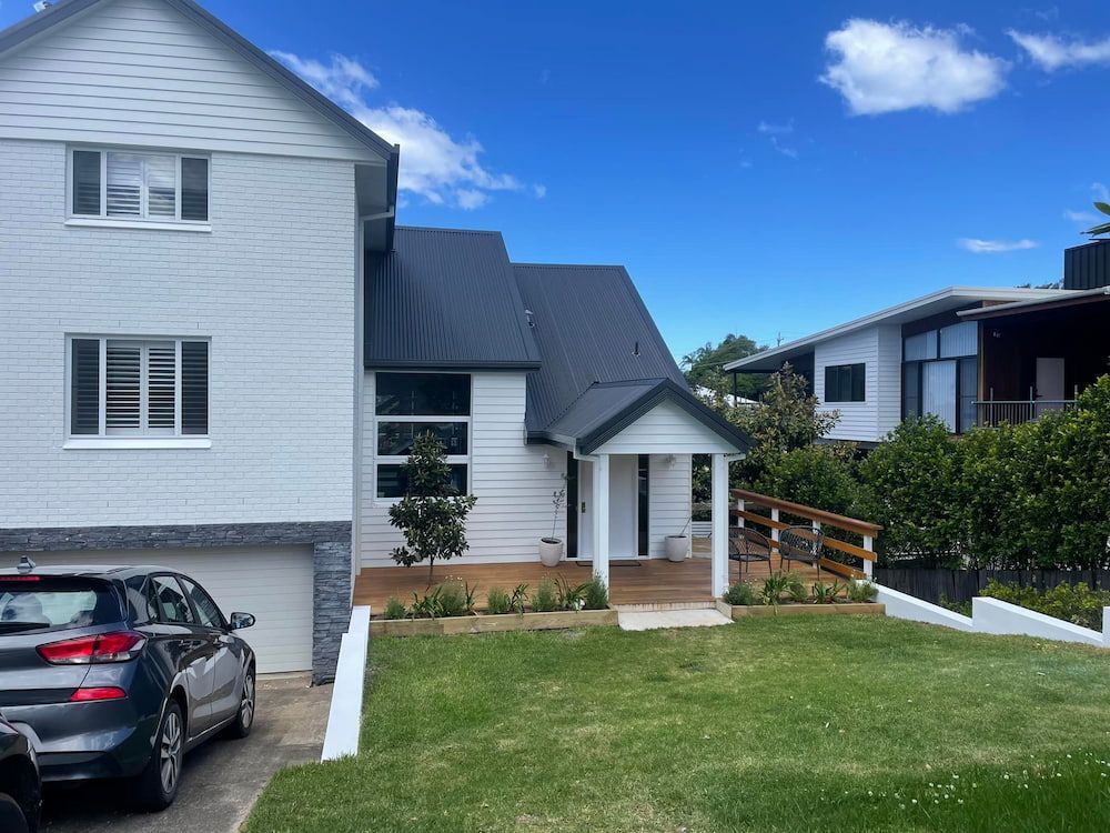 A Car is Parked in Front of a White House — Cornall Painting Services in Wauchope, NSW 
