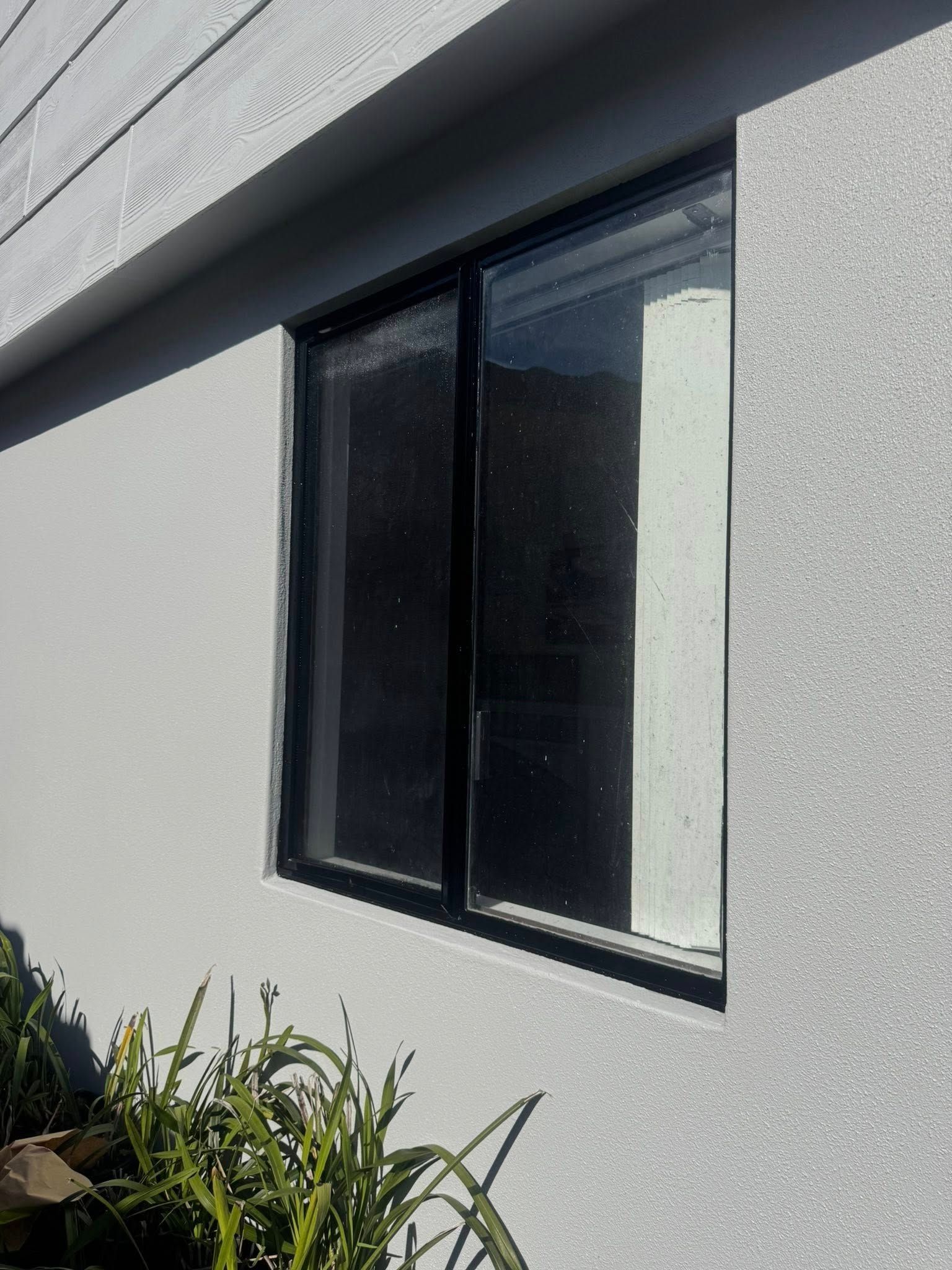 A single aluminium window on the side wall of a house - Cornall Painting Services in Wauchope NSW