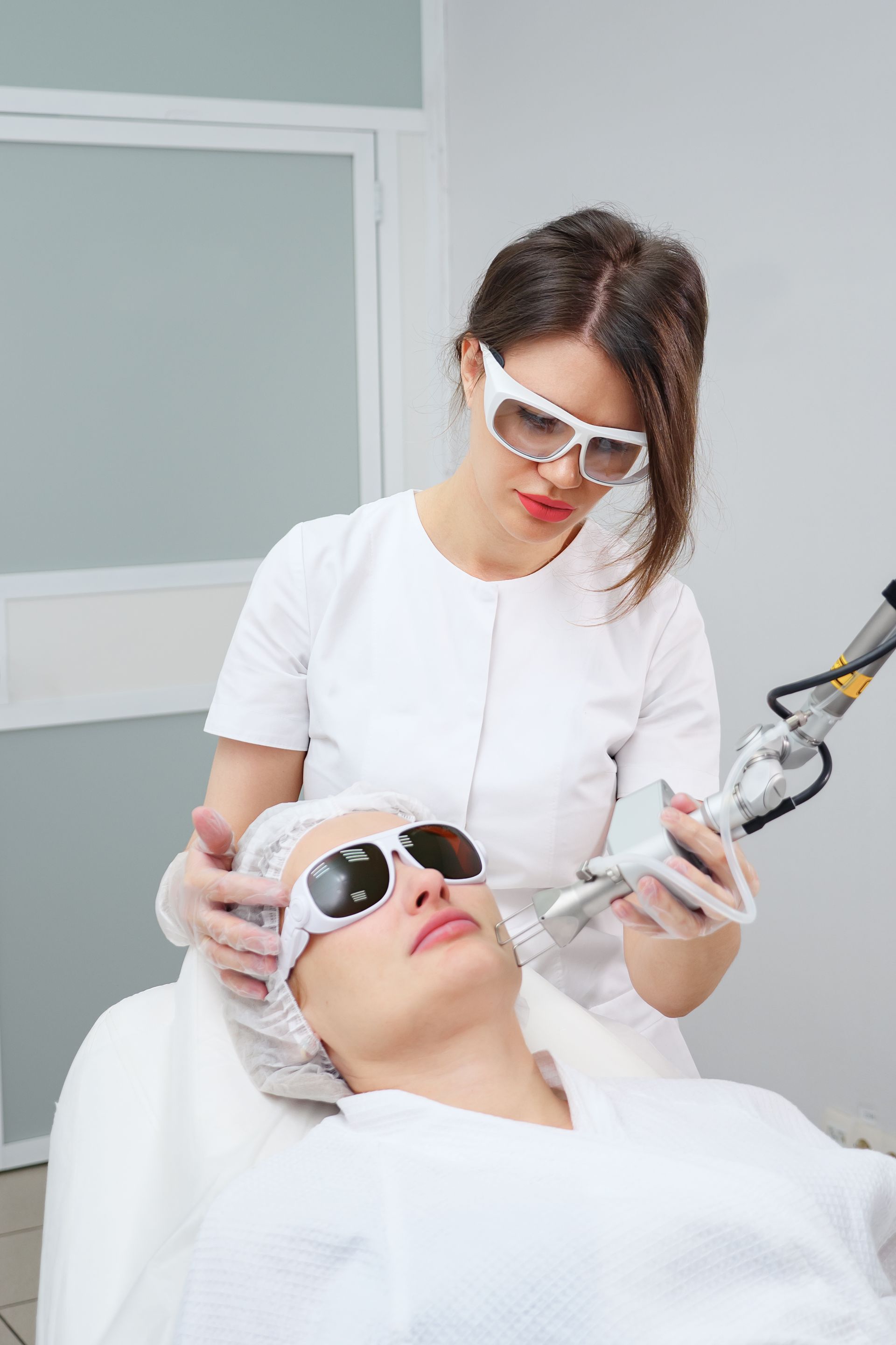 a woman is getting a laser treatment on her face .
