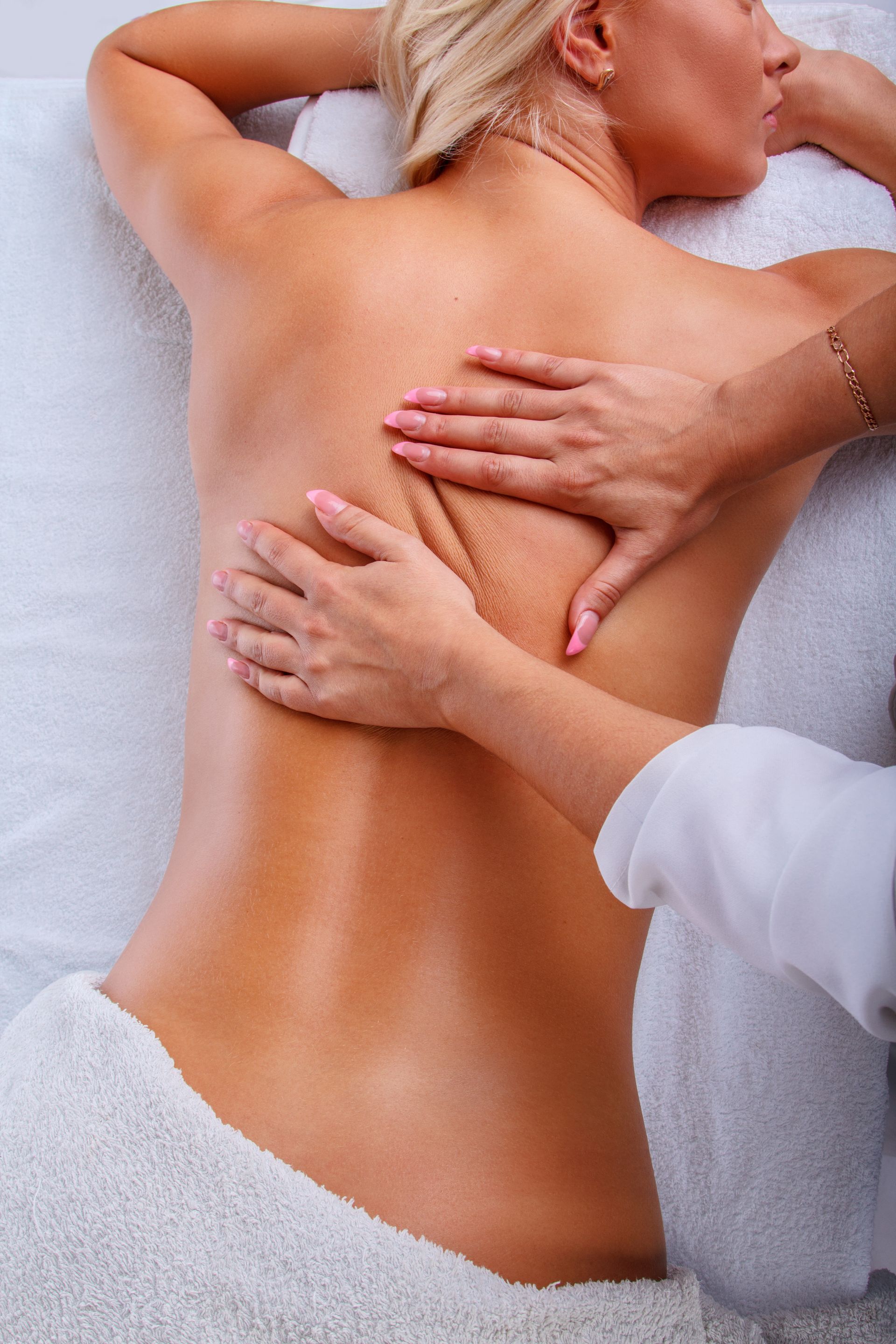 a woman is getting a massage on her back at a spa .