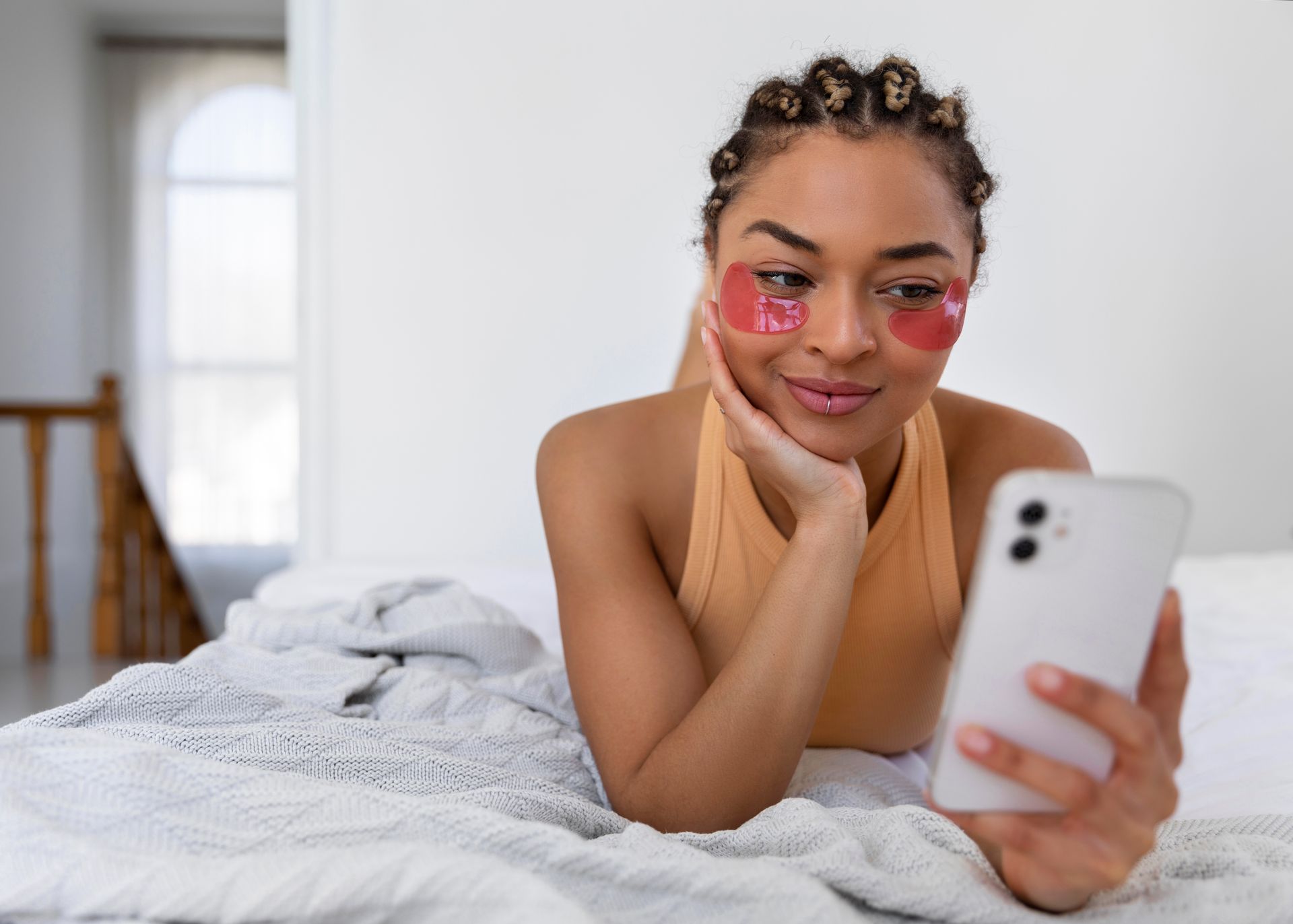 woman on bed on phone