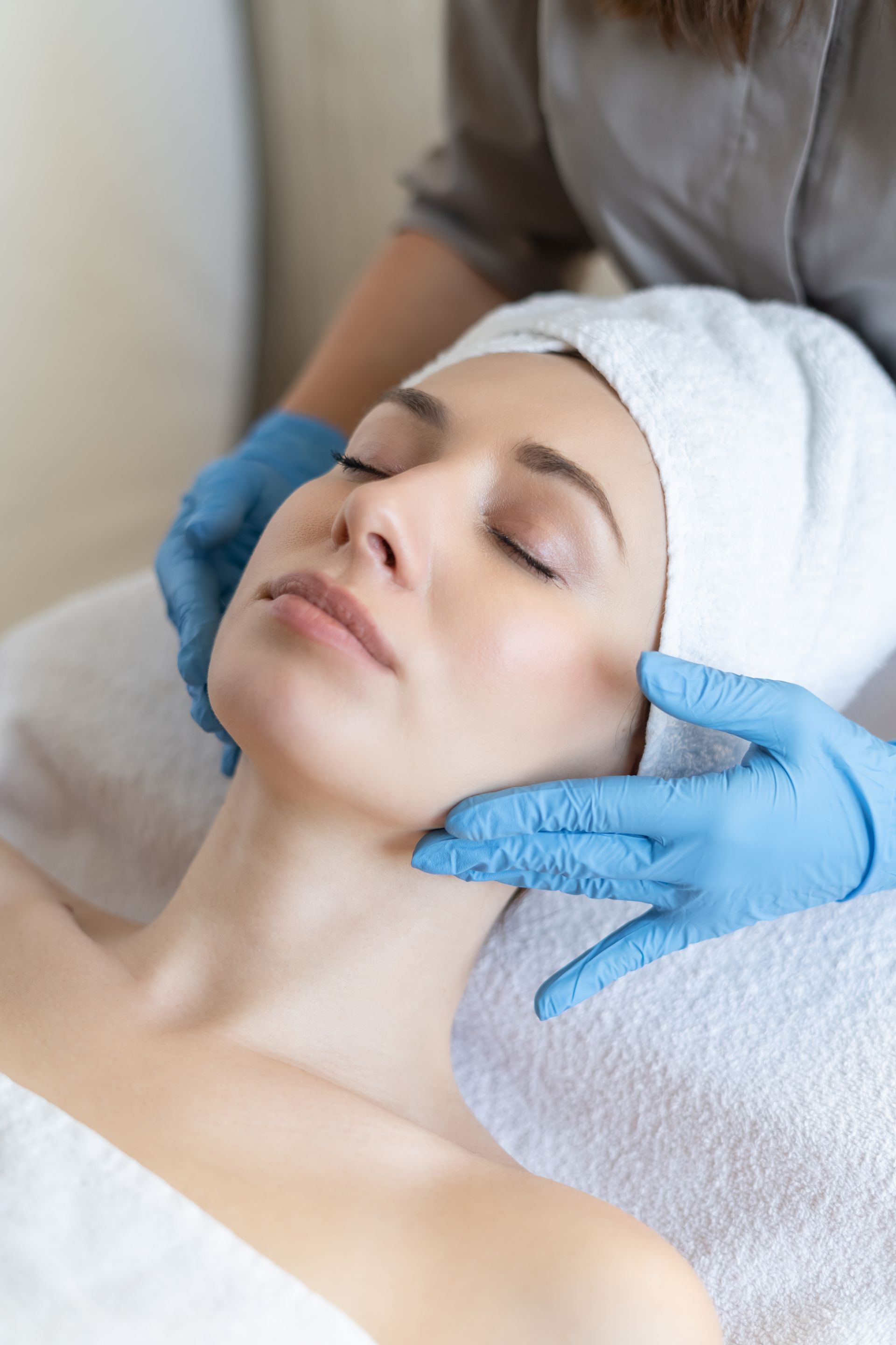 a woman is getting a facial treatment at a spa .