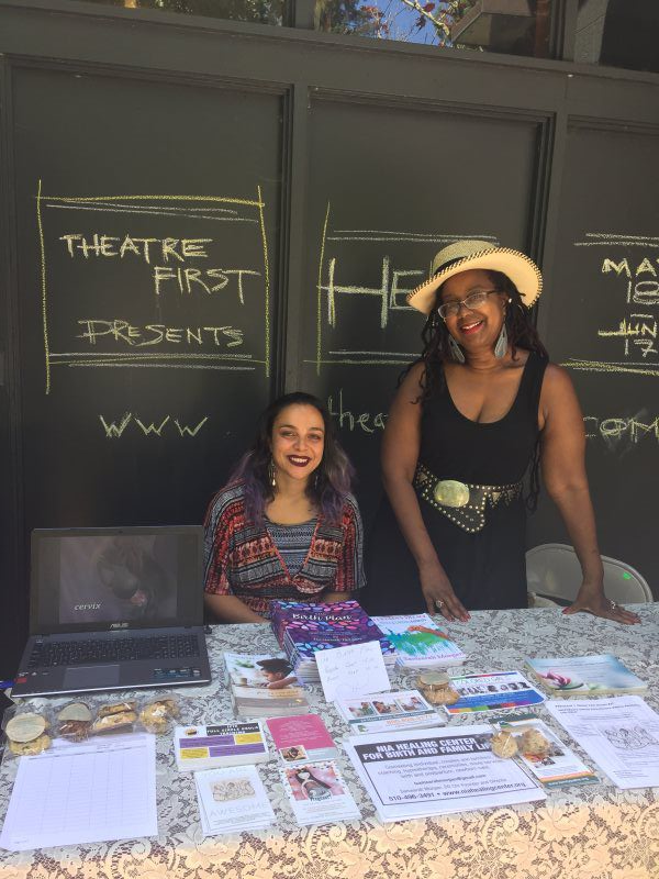Two women at a table promoting 