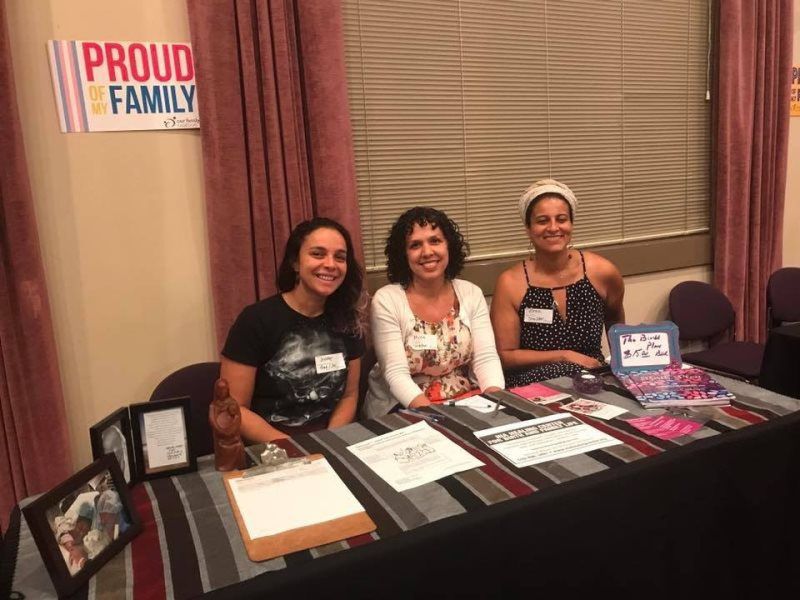 Three smiling people at a table with 