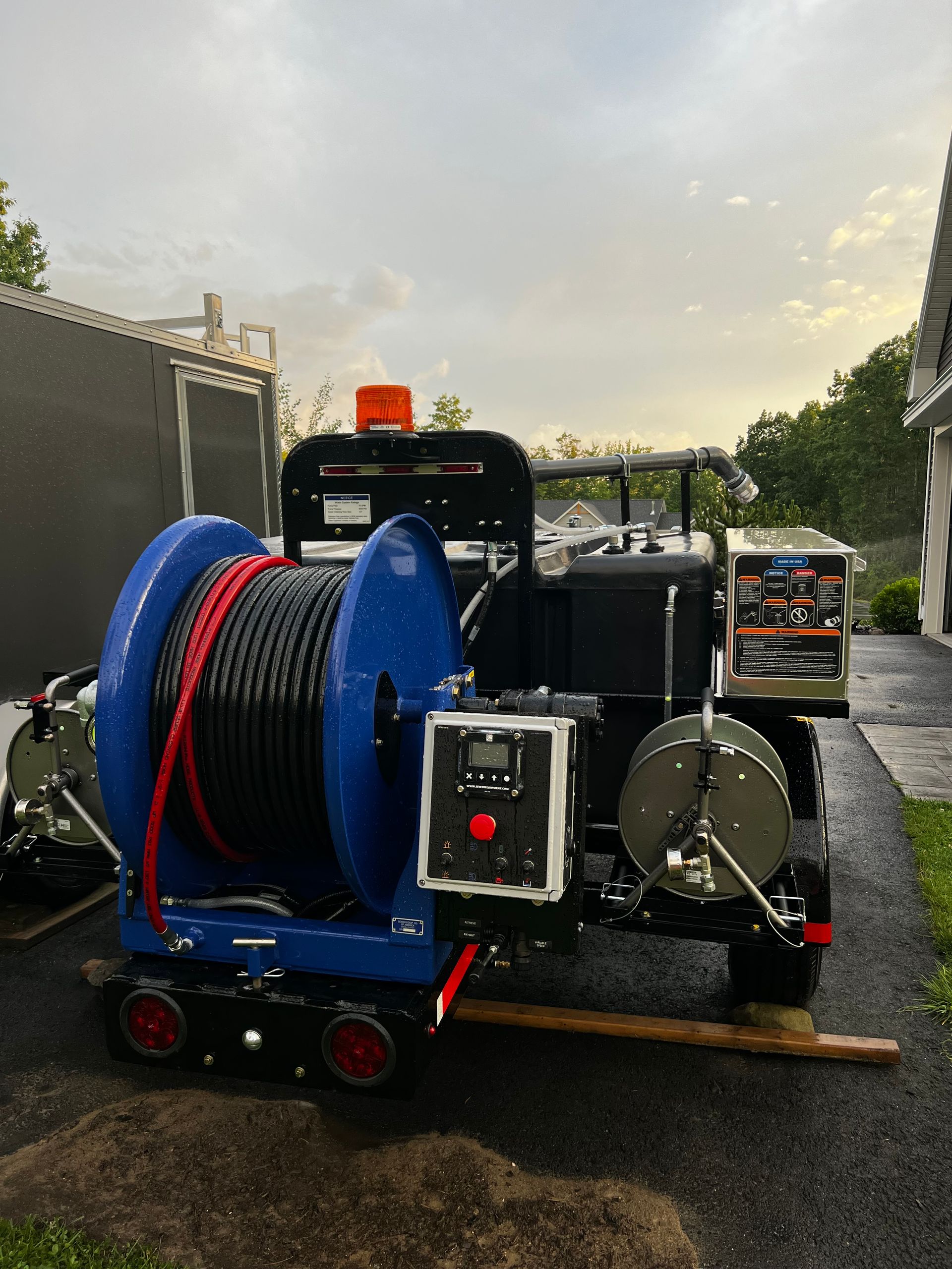 Man on a ladder installing a ceiling light in a kitchen