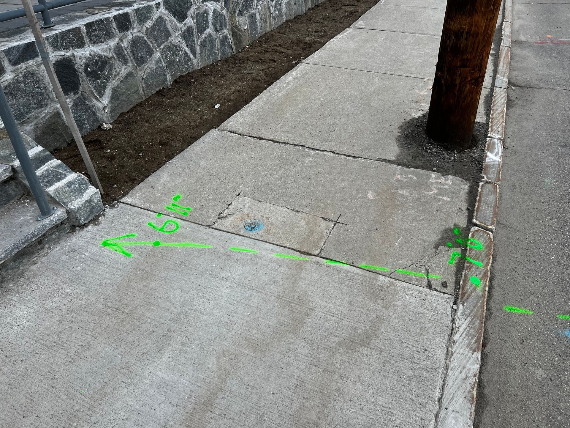 Man on a ladder installing a ceiling light in a kitchen