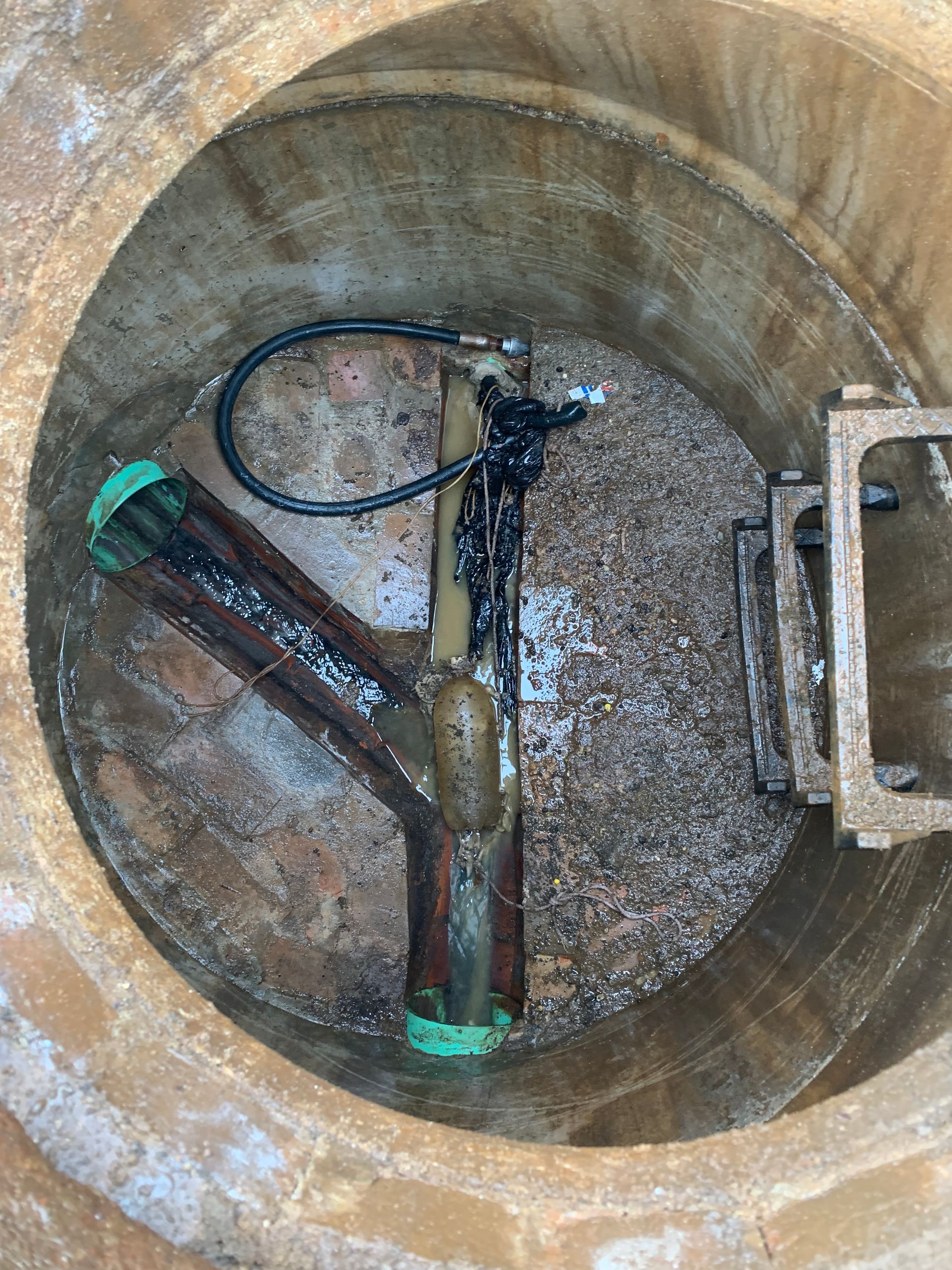 Man on a ladder installing a ceiling light in a kitchen