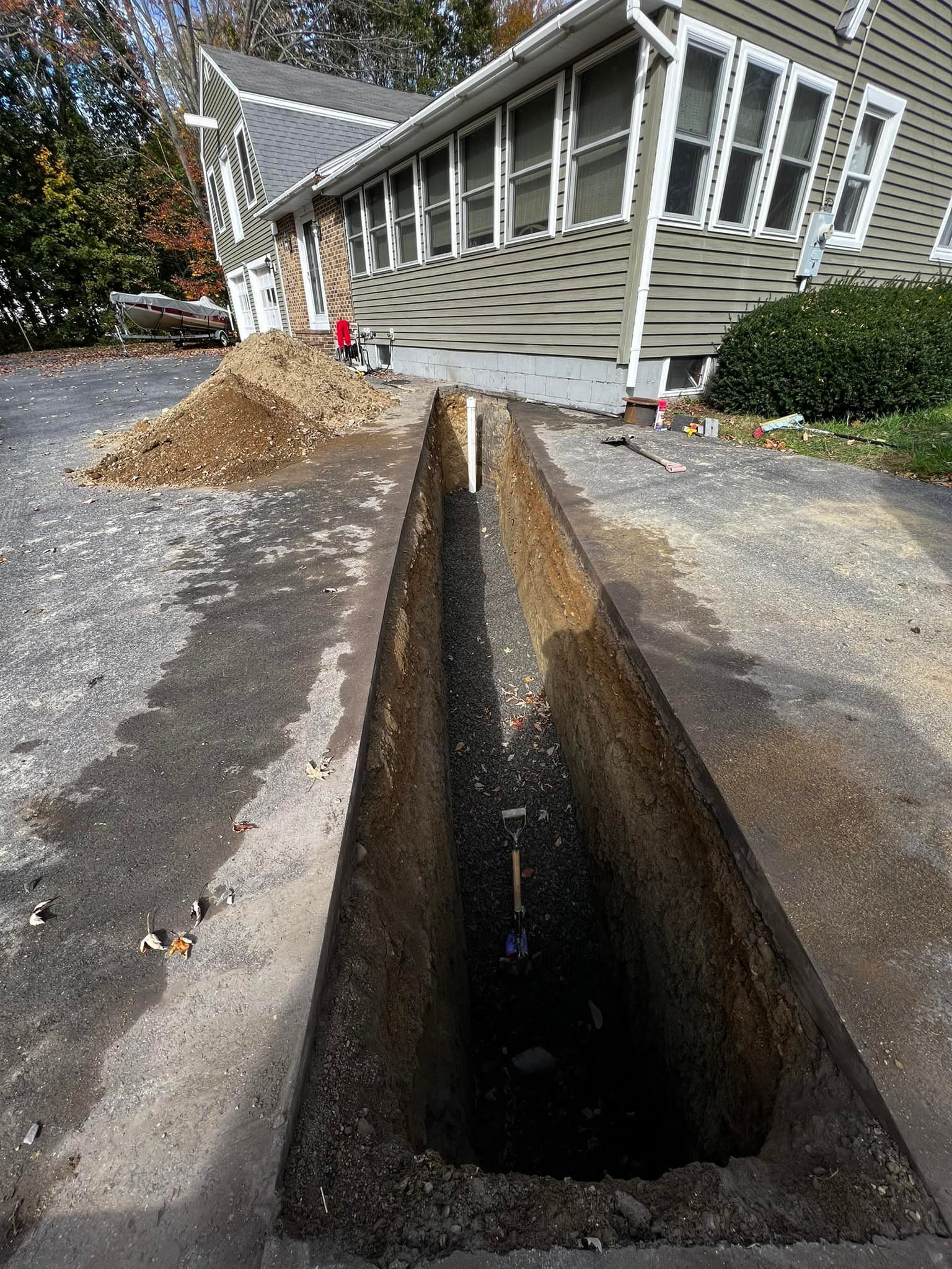 Man on a ladder installing a ceiling light in a kitchen