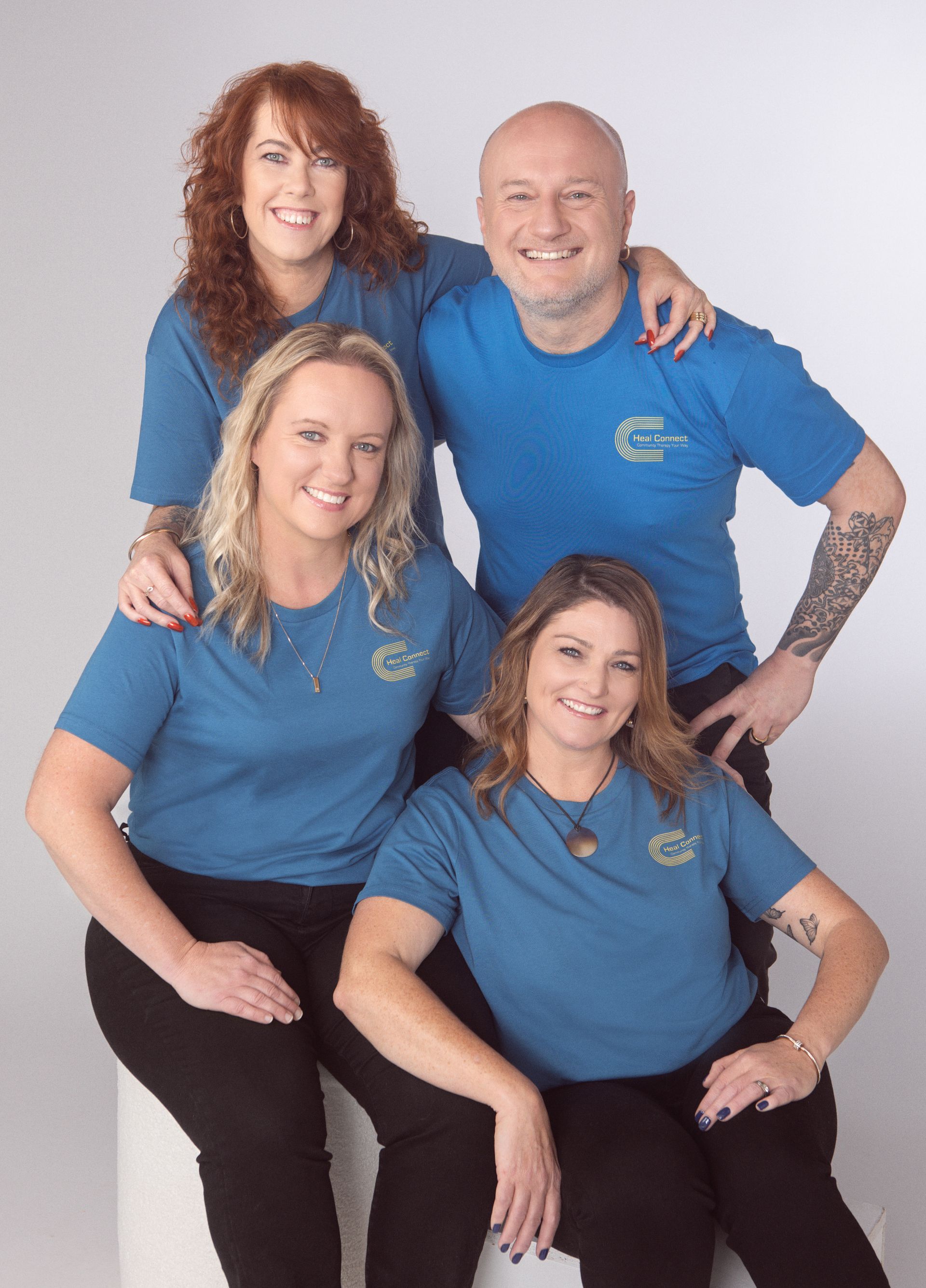 A Man And A Woman Are Standing Next To Each Other In Front Of A Building — Heal Connect in Long Jetty, NSW