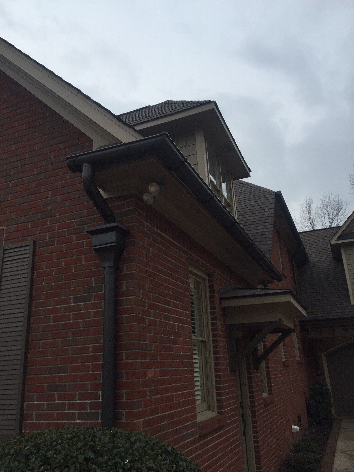 Roof, gutters, and downspout on brick home - B & B Roofing in Decatur, AL