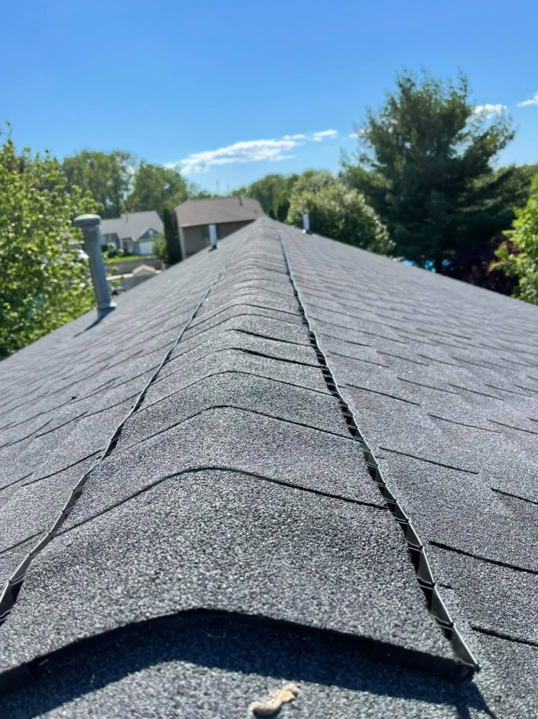 A close up of a roof with a blue sky in the background.