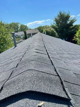 A close up of a roof with a blue sky in the background.