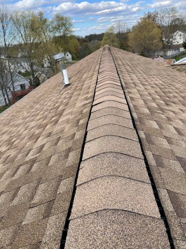 A close up of a roof with a drain on it.
