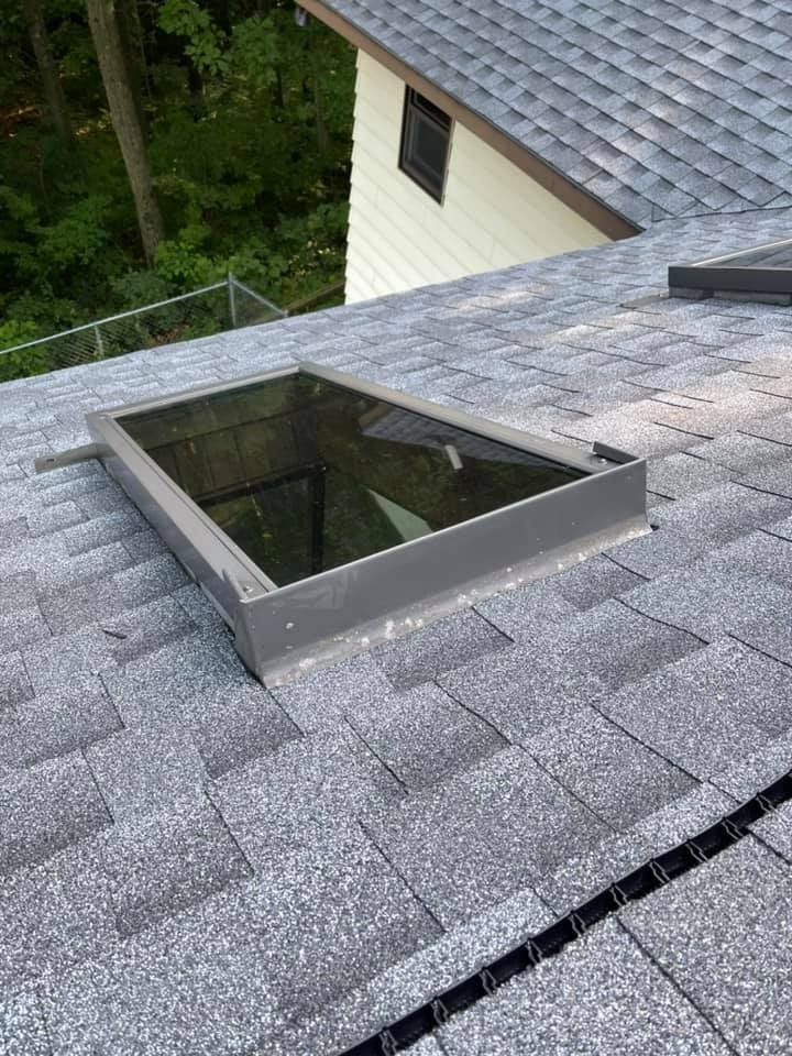 There is a skylight on the roof of a house.